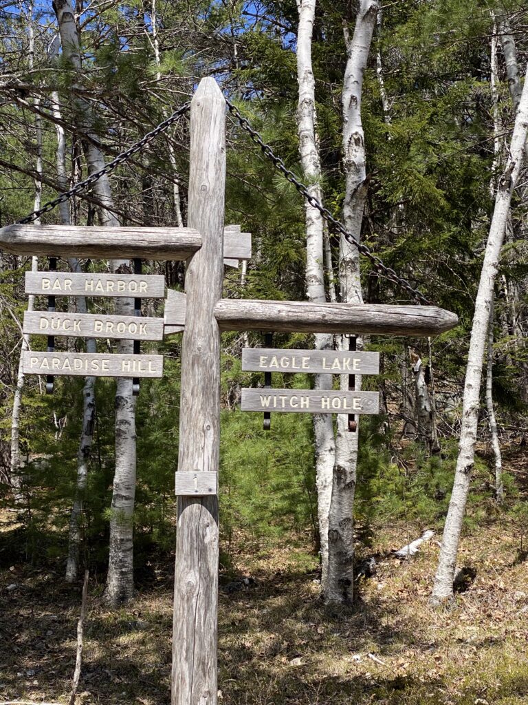 Carriage Road Trail signs on wooden pole. Acadia National Park