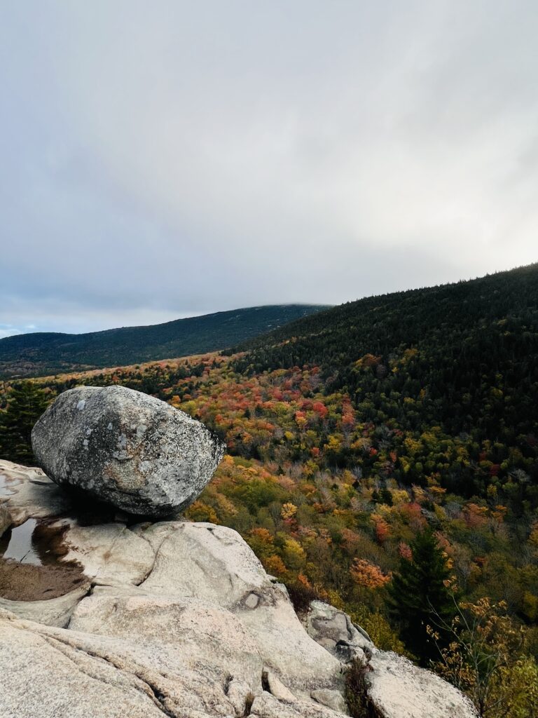 Boulder perching on edge of Mountain. Bubble Rock at Acadia National Park during the Fall.