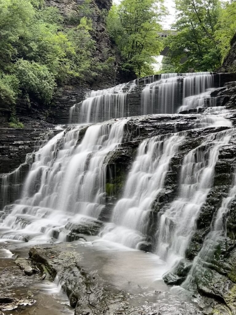 View from side of waterfall flowing into gorge
